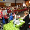 Kindergartners head to the checkout station Monday in the Holiday House at Bellview Elementary in Ro...