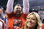 Bret Bielema and his wife Jen rejoice Saturday after Wisconsin’s victory in the Big Ten Championship Game at Indianapolis. Bielema, 42, displays a Wisconsin victory sign, forming a W with his thumbs and index fingers. Today, he will likely be calling the Hogs when introduced as Arkansas’ new coach.

