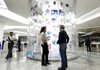 An America Movil SAB Telcel employee helps a customer at a store in Mexico City. Recent rulings and orders have cut into the wireless phone service provider’s profitability. 