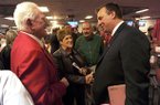 STAFF PHOTO ANDY SHUPE -- Former Arkansas athletics director Frank Broyles, left, speaks Wednesday, Dec. 5, 2012, with Bret Bielema, right, following a press conference to announce Bielema's hire as Razorbacks football coach in Fayetteville.
