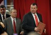 NWA Media/MICHAEL WOODS --12/05/2012-- Bret Bielema, the new University of Arkansas head football and athletics director Jeff Long enters the room to start the press conference Wednesday afternoon. 