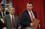 NWA Media/MICHAEL WOODS --12/05/2012-- Bret Bielema, the new University of Arkansas head football and athletics director Jeff Long enters the room to start the press conference Wednesday afternoon. 