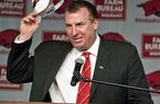 New Arkansas head coach Bret Bielema takes off his hat after being introduced during an NCAA college football news conference in Fayetteville, Ark., Wednesday, Dec. 5, 2012. Bielema, who will be paid $3.2 million annually for six years, replaces interim coach John L. Smith, who was hired after Bobby Petrino was fired in April