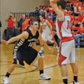 Austin Heard, left, a Bentonville senior guard, defends against Gravette’s Terence Pierce during the...