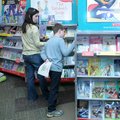 Jackson Miller, 9, right, and Melissa Miller look through books during the book fair. 