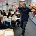 Clayton Scott, poet laureate of Fayetteville, uses props Tuesday to help teach Cori Fryar’s fifth-gr...