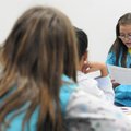 Elizabeth Sanchez, 10, reads a poem she wrote Tuesday at Lee Elementary School in Springdale. 