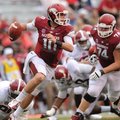 STAFF PHOTO ANDY SHUPE -- Arkansas quarterback Brandon Allen is tripped up by Alabama defensive line...