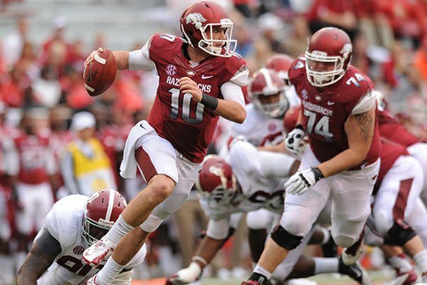 STAFF PHOTO ANDY SHUPE -- Arkansas quarterback Brandon Allen is tripped up by Alabama defensive lineman Quinton Dial during the fourth quarter of play Saturday, Sept. 15, 2012, at Razorback Stadium in Fayetteville.