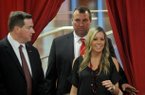 Arkansas football coach Bret Bielema follows his wife, Jen, into the Raymond Miller Room on Wednesday at Donald W. Reynolds Razorback Stadium. 