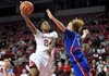 NWA Media/MICHAEL WOODS --12/06/2012-- Arkansas forward Quistelle Williams drives past Kansas defender Monica Engelman to score on a fast break during the first half of Thursday night's game at Bud Walton Arena in Fayetteville.