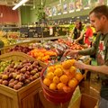 Jeff Alvine, staff member at the Ozark Natural Foods in Fayetteville, puts out fresh fruit Wednesday...