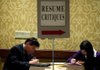 Job seekers fill out applications Tuesday at a job fair in San Jose, Calif. Nationally, applications for unemployment benefits fell last week to a seasonally adjusted 370,000. 
