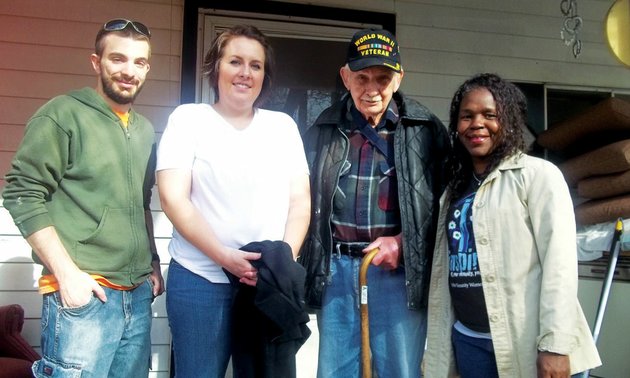 herbert-lucky-page-a-world-war-ii-veteran-stands-on-the-porch-of-the-home-he-shares-with-his-wife-monnie-on-lake-conway-volunteers-working-to-renovate-the-home-include-from-the-left-hendrix-students-eric-monroe-kaily-kilcrease-and-shenel-sandidge-executive-director-of-habitat-for-humanity-of-faulkner-county-the-nonprofit-organization-is-partnering-with-home-depot-of-conway-and-community-volunteers-on-the-project