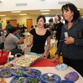 Student Erica Estrada, left, shows Karen Steen, Heritage High School principal, some of the baked go...