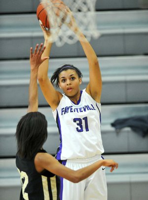 Fayetteville’s Vanessa Matlock (31) pulls up for a jumper over Little Rock Central defender Jasmine Cashaw during the Lady Bulldogs’ 49-46 loss to the Lady Tigers on Friday at the Lady Bulldog Classic in Fayetteville. 