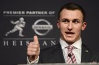 Texas A&M quarterback Johnny Manziel gestures as he talks to reporters after becoming the first freshman to win the Heisman Trophy, college football's top individual prize, Saturday, Dec. 8, 2012, in New York. (AP Photo/Henny Ray Abrams)