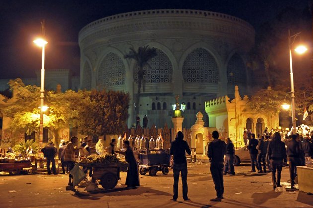 vendors-provide-demonstrators-with-food-and-drink-outside-the-presidential-palace-after-tens-of-thousands-marched-on-the-presidential-palace-pushing-past-barbed-wire-fences-installed-by-the-army-in-cairo-egypt-during-the-early-hours-of-saturday-dec-8-2012-egypt-postponed-early-voting-on-a-contentious-draft-constitution-and-aides-to-president-mohammed-morsi-floated-the-possibility-of-canceling-the-whole-referendum-in-the-first-signs-friday-that-the-islamic-leader-is-finally-yielding-to-days-of-protests-and-deadly-street-clashes