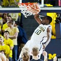 Michigan guard Tim Hardaway Jr., (10) dunks the ball in the first half of an NCAA college basketball...