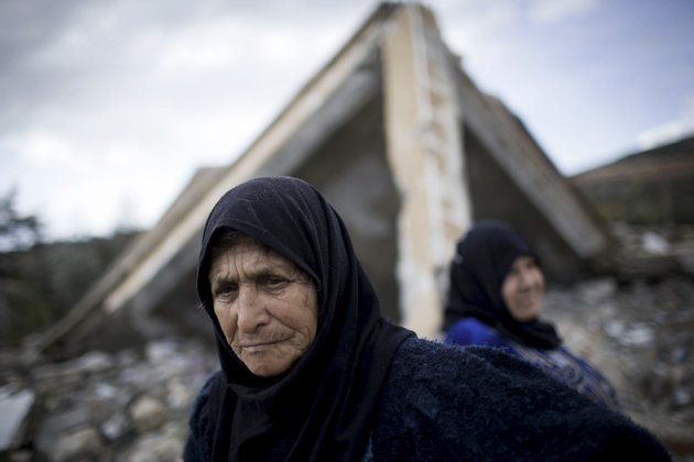 syrian-women-stand-amid-the-ruins-of-their-farm-destroyed-by-syrian-army-jets-in-al-hafriyeh-village-syria-saturday-dec-8-2012-syrian-rebel-commanders-have-elected-a-new-30-member-leadership-council-and-a-chief-of-staff-a-senior-rebel-said-saturday-in-a-major-step-toward-unifying-the-opposition-that-is-fighting-to-oust-president-bashar-assad-the-supreme-military-council-which-was-chosen-friday-during-a-meeting-in-turkey-will-work-with-the-political-leadership-that-was-chosen-last-month-in-qatar