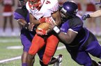 News-Times/Michael OrrellEl Dorado defensive lineman Bijhon Jackson, right, takes down Camden Fairview Darius Fletcher (4), in the Wildcats season opener at Memorial Stadium on Friday. 