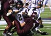 Ozark’s Josef Asbeck is brought down by Stuttgart defenders Jon Curtis (1) and Jackson Kennedy. The Ricebirds held the Hillbillies to 119 total yards. 