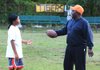 Ed Johnson, better known as Coach Ed, questions Dylan Lowery, 12, the varsity captain of the Sunset Tigers, about why he left his helmet at home before a practice at their field in Little Rock’s Southside Park on Sept. 19. 