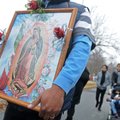 Ruben Alvarado Corona from St. Raphael Catholic Church in Springdale holds a picture of the Virgin M...