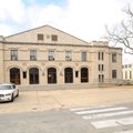 A student crosses Garland Avenue before entering the temporary home of the University of Arkansas Fa...