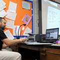 Eric Chavez, math tutor at Southwest Junior High School, runs through how to solve an equation Thurs...