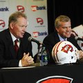 New Western Kentucky head coach Bobby Petrino, left, speaks with athletic director Todd Stewart duri...