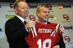 New Western Kentucky head coach Bobby Petrino, left, holds up a jersey with athletic director Todd Stewart during an NCAA college football news conference, Monday, Dec. 10, 2012, in Bowling Green, Ky. The 51-year-old was fired by Arkansas in April for a "pattern of misleading" behavior following an accident in which the coach was injured while riding a motorcycle with his mistress as a passenger but now wants to make the most of his second chance. (AP Photo/The Daily News, Joe Imel)