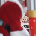 Hudson Switzer, 20 months, of Springdale smiles Monday as Santa Claus prepares for a day of having h...
