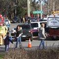 Parents walk away from the Sandy Hook Elementary School with their children following a shooting, Fr...