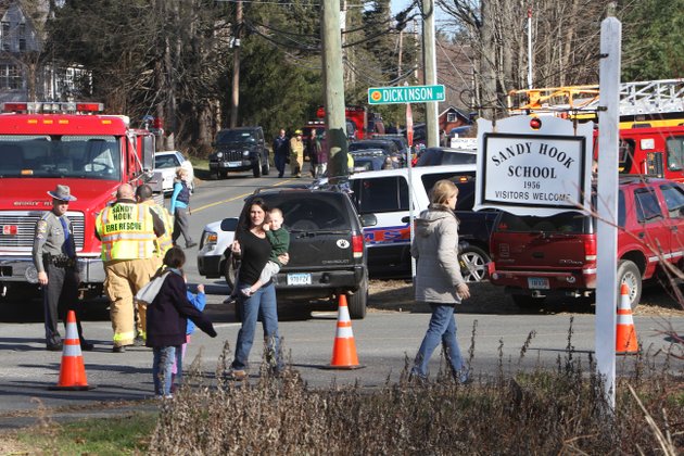 parents-walk-away-from-the-sandy-hook-elementary-school-with-their-children-following-a-shooting-friday-dec-14-2012-in-newtown-conn