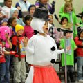 Madelyn Smith, a first-grader dressed as a snowman, sings with her classmates during their presentat...