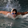 Corey Evans, 17, of Springdale Har-Ber swims the fly Tuesday during practice at The Jones Center in ...