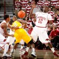 Arkansas freshman Dee Wagner (left) and junior Fred Gulley (right) force a turnover by Alcorn State ...