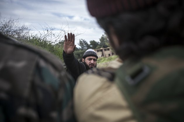 in-this-saturday-dec-15-2012-photo-a-free-syrian-army-fighter-leads-his-comrades-during-heavy-clashes-with-government-forces-at-a-military-academy-besieged-by-the-rebels-north-of-aleppo-syria-free-syrian-army-fighters-took-control-over-the-military-academy-after-battling-government-forces-for-several-hours