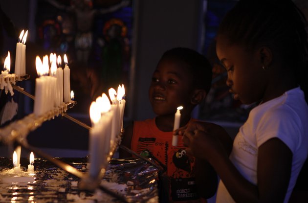 worshippers-light-candles-and-dedicate-prayers-at-the-rosebank-catholic-church-in-johannesburg-sunday-dec-16-2012-south-africas-former-president-nelson-mandela-underwent-a-successful-surgery-to-remove-gallstones-saturday-the-nations-presidency-said-as-the-94-year-old-anti-apartheid-icon-is-still-recovering-from-a-lung-infection-doctors-treating-mandela-waited-to-perform-the-endoscopic-surgery-as-they-wanted-to-first-attend-to-his-lung-ailment-presidential-spokesman-mac-maharaj-said-in-a-statement-mandela-has-been-hospitalized-since-dec-8
