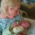 Leslie Harris cradles her newborn son, Ayden, in an oncology ward, where she was undergoing chemothe...