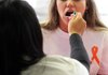 Nittara Lauland swabs the mouth of Amber Church during a March bone-marrow drive at the Lakewood Village Shopping Park in North Little Rock. 
