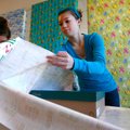Kennedy Bohannon, right, 16, and Marlie Ball, 16, both of Gravette, wrap gifts on Sunday at the Pinn...