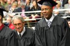 NWA Media/MICHAEL WOODS --12/15/2012-- Former University of Arkansas basketball player Darrell Walker, right, who played with the Razorbacks from 1980-83 is accompanied by former University of Arkansas basketball coach Eddie Sutton who coached at Arkansas from 1974-1985, as they participate in the fall commencement ceremony at Barnhill Arena in Fayetteville on Saturday morning. Sutton had the honor of presenting Walker with his degree. Over 800 undergraduate, graduate and law students who completed their studies during the summer or fall semesters will took part in the commencement ceremony.
