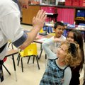 Scott Walker, with Mid-America Karate, gets a high-five from Amore Derossi, 5, Monday after she prac...