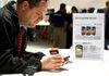 A visitor at the Consumer Electronics Show in Las Vegas looks at a Samsung Electronics Co. Galaxy S II phone earlier this year. A federal judge Monday rejected Apple Inc.’s demand that Samsung stop selling phones found infringing on Apple patents. 