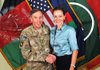 Gen. David Petraeus, the former commander of coalition and U.S. forces in Afghanistan, shakes hands with Paula Broadwell, in this July 13, 2011, photo made available on the International Security Assistance Force’s Flickr website. 