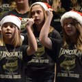 Farrah Russo, 12, left, Alexys Roland, 12, right, and Mackenzie Mason, 12, top, perform a “Santa Cla...