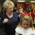 Linda Colton of Hot Springs, left, styles the hair of her granddaughter, third-grade student Kristen...