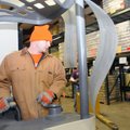 Grant Brand, warehouse supervisor at the Northwest Arkansas Food Bank, reorganizes the freezer Tuesd...
